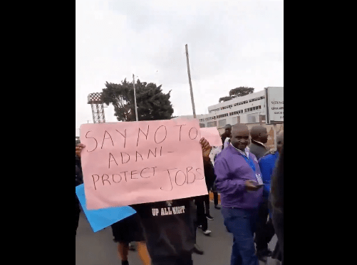 JKIA at a Standstill Workers Protest Against Adani Group Takeover. A placard carried by one of the protestors during the workers demos. Picture/Courtesy